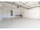 Clean and spacious garage with epoxy floor, storage shelves, and water heater at 9404 Calico Garden Ave, Las Vegas, NV 89134