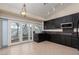 Kitchen area with dark wood cabinets, stainless steel appliances, and a view of the backyard at 9404 Calico Garden Ave, Las Vegas, NV 89134