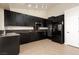 Well-equipped kitchen with black cabinets, stainless steel appliances, and tiled flooring at 9404 Calico Garden Ave, Las Vegas, NV 89134