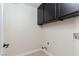 The laundry room has cabinets above the washer and dryer hookups at 9404 Calico Garden Ave, Las Vegas, NV 89134