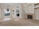 Open-concept living room with a fireplace, tile flooring, and carpet, perfect for entertaining at 9404 Calico Garden Ave, Las Vegas, NV 89134