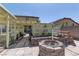 View of a cozy backyard space with a fire pit and lattice covered patio at 952 Crescent Falls St, Henderson, NV 89011