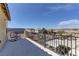 Wide outdoor balcony with wrought iron railings offering views of the surrounding mountains and neighborhood at 952 Crescent Falls St, Henderson, NV 89011