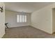 Carpeted room featuring plantation shutters on a window, a ceiling light, and bright neutral paint at 952 Crescent Falls St, Henderson, NV 89011