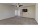 Spacious bedroom features a ceiling fan, plush carpet, and access to the ensuite bathroom and balcony at 952 Crescent Falls St, Henderson, NV 89011