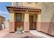 Inviting front entrance with a covered porch, decorative pillars, desert landscaping, and neutral colors at 952 Crescent Falls St, Henderson, NV 89011