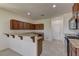 Kitchen with granite countertops, stainless steel appliances, dark wood cabinetry, and tile floors at 952 Crescent Falls St, Henderson, NV 89011