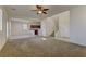 Open-concept living room with large windows, carpet flooring, staircase, and a view of the kitchen at 952 Crescent Falls St, Henderson, NV 89011