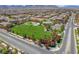 Vibrant community aerial view featuring a park and tennis courts amid meticulously planned homes at 9654 Ponderosa Skye Ct, Las Vegas, NV 89166