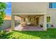 Well-maintained backyard featuring a covered patio and verdant lawn at 9654 Ponderosa Skye Ct, Las Vegas, NV 89166