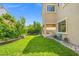 Lush backyard with manicured lawn and stone accents, perfect for outdoor enjoyment at 9654 Ponderosa Skye Ct, Las Vegas, NV 89166