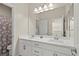 This bathroom includes a double vanity with neutral countertop and tub/shower combo at 9654 Ponderosa Skye Ct, Las Vegas, NV 89166