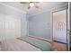 Calm bedroom with wood floors, a closet, light blue walls, and access to the private patio at 9654 Ponderosa Skye Ct, Las Vegas, NV 89166