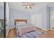Serene bedroom with wood floors, a ceiling fan, a closet, and a door to the courtyard at 9654 Ponderosa Skye Ct, Las Vegas, NV 89166