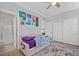 Cozy bedroom featuring a colorful rug, ample closet space, and adjacent bathroom at 9654 Ponderosa Skye Ct, Las Vegas, NV 89166