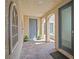 Inviting courtyard featuring tiled flooring, stucco walls, and an arched walkway with plants at 9654 Ponderosa Skye Ct, Las Vegas, NV 89166