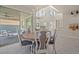 Bright dining room with modern chandelier, outdoor patio access and neutral tones creates an inviting space at 9654 Ponderosa Skye Ct, Las Vegas, NV 89166
