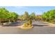 Gated community entrance with mature trees and landscaping, ensuring privacy and a welcoming ambiance at 9654 Ponderosa Skye Ct, Las Vegas, NV 89166