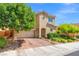 Lovely two-story home featuring mature trees, brick paver driveway, and lush landscaping at 9654 Ponderosa Skye Ct, Las Vegas, NV 89166