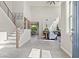 Bright foyer with tile floors, a staircase with metal railings, and an open view to the living area at 9654 Ponderosa Skye Ct, Las Vegas, NV 89166