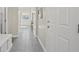 Inviting hallway with tiled flooring, neutral tones, and ample natural light, leading to various rooms at 9654 Ponderosa Skye Ct, Las Vegas, NV 89166