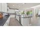 Spacious kitchen featuring white cabinetry, stainless steel appliances, dark countertops and a large island at 9654 Ponderosa Skye Ct, Las Vegas, NV 89166