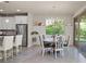 Eat-in kitchen featuring stainless steel appliances, granite counters, and a dining area at 9654 Ponderosa Skye Ct, Las Vegas, NV 89166