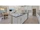 Open kitchen featuring a large island, white cabinets and stainless steel appliances with adjoining dining area at 9654 Ponderosa Skye Ct, Las Vegas, NV 89166