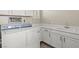 Well-organized laundry area with white cabinets, a sink, and modern appliances at 9654 Ponderosa Skye Ct, Las Vegas, NV 89166
