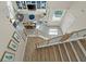 Open concept view from stairway into living room featuring custom built-ins, furniture and ample light at 9654 Ponderosa Skye Ct, Las Vegas, NV 89166