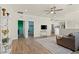 Spacious living room with hardwood flooring and neutral tones, seamlessly connects various rooms and living spaces at 9654 Ponderosa Skye Ct, Las Vegas, NV 89166