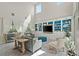 Inviting living room with high ceilings, large windows, and custom shelving for display at 9654 Ponderosa Skye Ct, Las Vegas, NV 89166