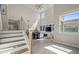 Bright living room features high ceilings, large windows, custom built-ins, and modern staircase at 9654 Ponderosa Skye Ct, Las Vegas, NV 89166