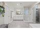 This bathroom includes a double vanity, glass shower, and neutral color palette at 9654 Ponderosa Skye Ct, Las Vegas, NV 89166