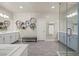 A bright bathroom with double sinks, soaking tub, walk in shower, and hexagon shelving at 9654 Ponderosa Skye Ct, Las Vegas, NV 89166