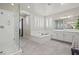 A bright bathroom with double sinks, soaking tub, walk in shower, and hexagon shelving at 9654 Ponderosa Skye Ct, Las Vegas, NV 89166