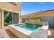 Backyard spa pool with a stone border and a view of the neighboring red-tile roof at 9654 Ponderosa Skye Ct, Las Vegas, NV 89166