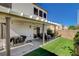 Backyard features an extended pergola patio with synthetic grass and seating area at 9931 Cherry Melee Ave, Las Vegas, NV 89148
