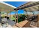 Wide-angle view of the backyard featuring a pergola, patio, synthetic grass, grill, and seating at 9931 Cherry Melee Ave, Las Vegas, NV 89148