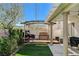 Backyard view with pergola, bench, grill, and an area of synthetic grass at 9931 Cherry Melee Ave, Las Vegas, NV 89148