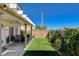 Artificial turf area with covered patio including seating, grill, landscaping and block wall fence at 9931 Cherry Melee Ave, Las Vegas, NV 89148