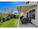 Backyard with a covered patio and artificial grass, creating a relaxed outdoor space at 9931 Cherry Melee Ave, Las Vegas, NV 89148