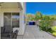 Backyard featuring a covered patio and lush greenery, blending indoor comfort with outdoor charm at 9931 Cherry Melee Ave, Las Vegas, NV 89148