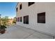 Home exterior with a tidy patio area, bordered by verdant landscaping and a sturdy privacy fence at 9931 Cherry Melee Ave, Las Vegas, NV 89148