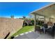 Inviting backyard with a covered patio and manicured lawn, creating a perfect outdoor retreat at 9931 Cherry Melee Ave, Las Vegas, NV 89148
