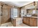 Bright bathroom with a glass door shower, soaking tub, vanity with vessel sink, and warm lighting at 9931 Cherry Melee Ave, Las Vegas, NV 89148