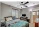 Bedroom with a fan, computer desk and a view of the surrounding neighborhood at 9931 Cherry Melee Ave, Las Vegas, NV 89148