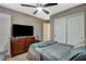 Bedroom with fan, dresser, closet, and modern electronics creating an inviting space at 9931 Cherry Melee Ave, Las Vegas, NV 89148