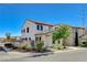A two-story townhouse with stucco exterior, tile roof, and a well-maintained front yard on a sunny day at 9931 Cherry Melee Ave, Las Vegas, NV 89148