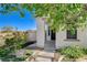 Inviting front porch with stone accents, green landscaping, and a charming entrance to the home at 9931 Cherry Melee Ave, Las Vegas, NV 89148